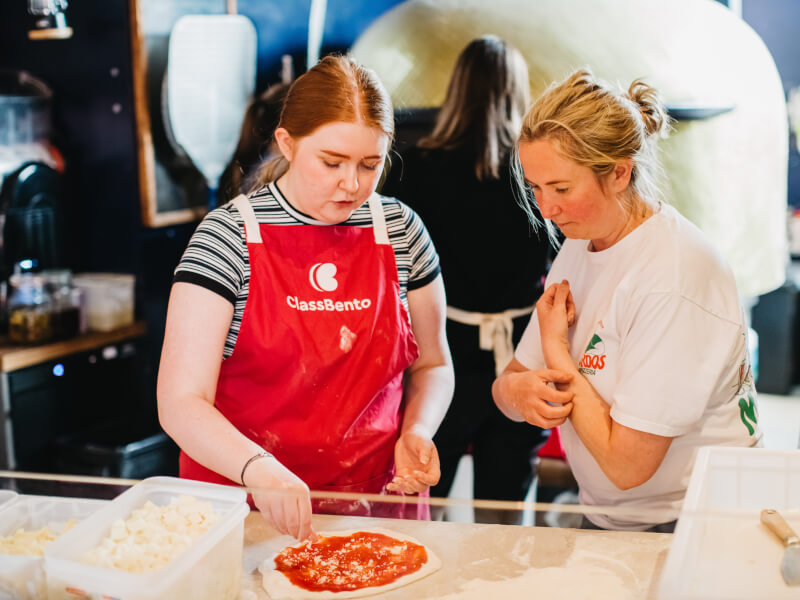 Employees making pizza at a cooking class for team building